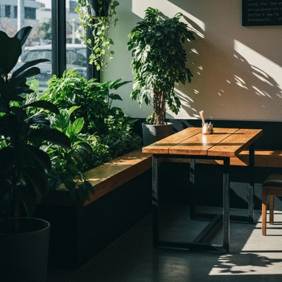 Interior of a modern cafe featuring lush green plants and wooden furniture